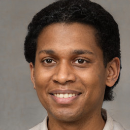 Joyful latino young-adult male with short  brown hair and brown eyes