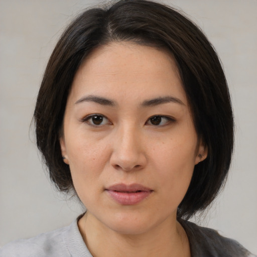 Neutral asian young-adult female with medium  brown hair and brown eyes