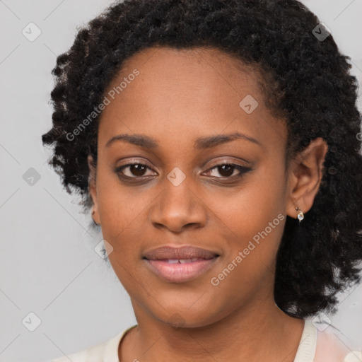 Joyful black young-adult female with long  black hair and brown eyes