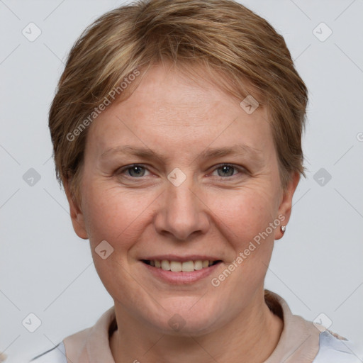 Joyful white adult female with short  brown hair and grey eyes