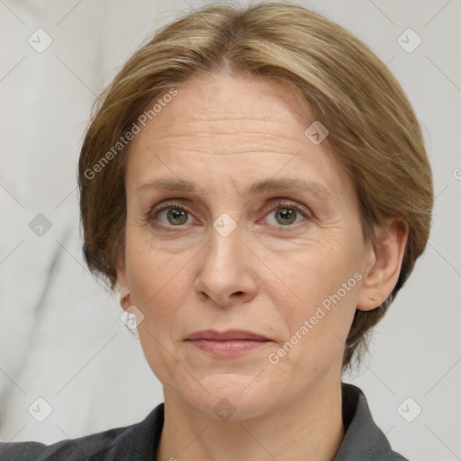 Joyful white adult female with medium  brown hair and grey eyes