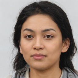 Joyful latino young-adult female with long  brown hair and brown eyes