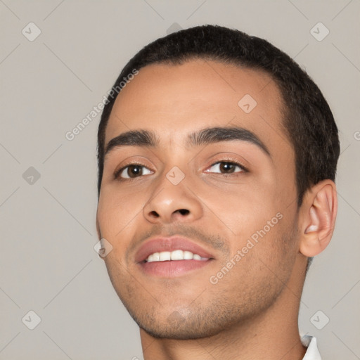 Joyful white young-adult male with short  black hair and brown eyes