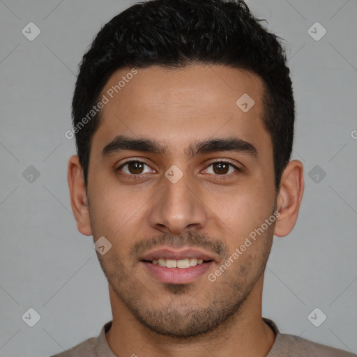 Joyful white young-adult male with short  black hair and brown eyes