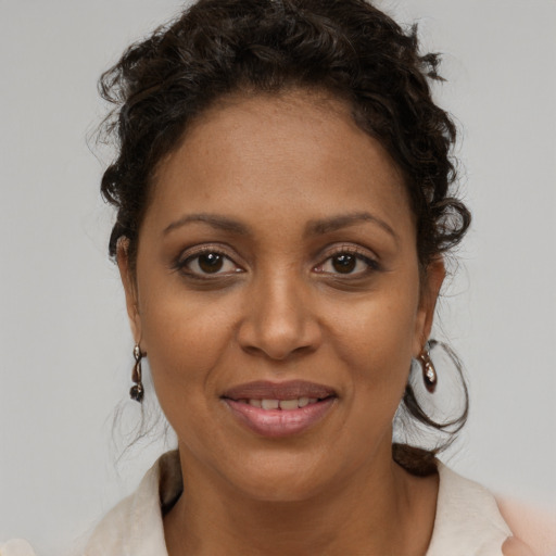 Joyful black young-adult female with medium  brown hair and brown eyes