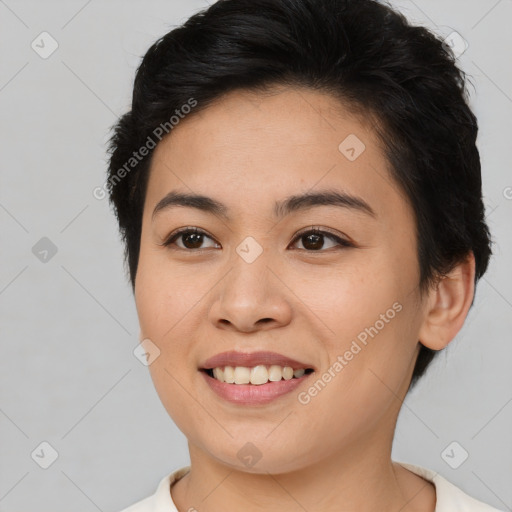 Joyful asian young-adult female with short  brown hair and brown eyes