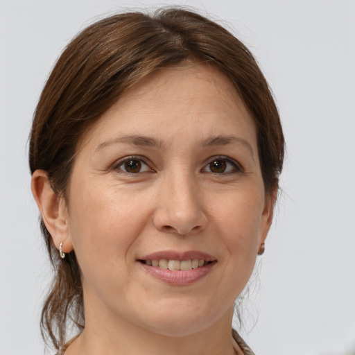 Joyful white adult female with medium  brown hair and brown eyes