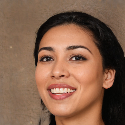 Joyful white young-adult female with long  black hair and brown eyes