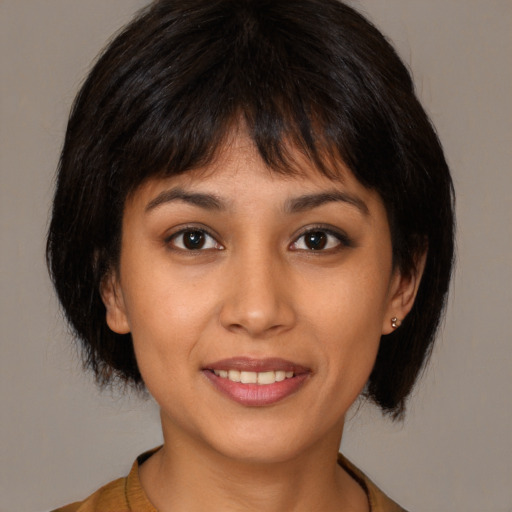 Joyful latino young-adult female with medium  brown hair and brown eyes