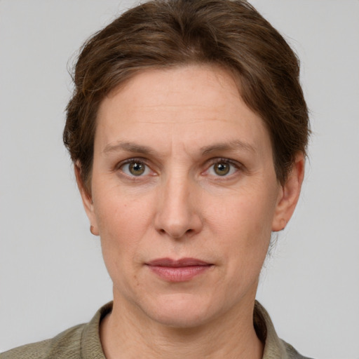 Joyful white adult female with short  brown hair and grey eyes