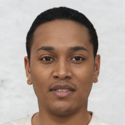 Joyful black young-adult male with short  black hair and brown eyes