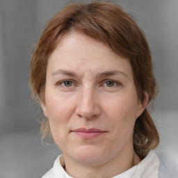 Joyful white adult female with medium  brown hair and grey eyes