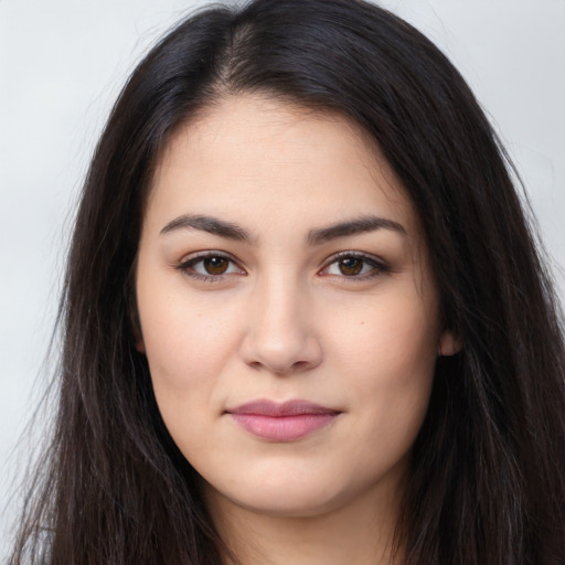 Joyful latino young-adult female with long  brown hair and brown eyes