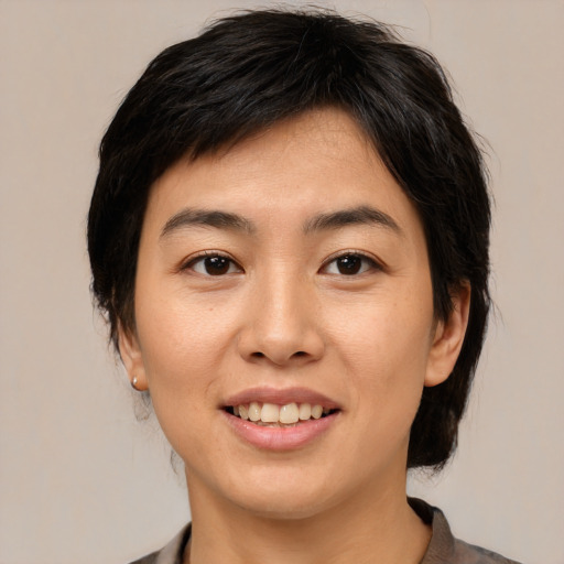 Joyful asian young-adult female with medium  brown hair and brown eyes