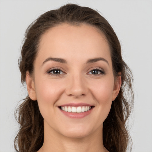 Joyful white young-adult female with long  brown hair and grey eyes