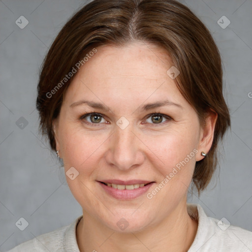 Joyful white adult female with medium  brown hair and grey eyes