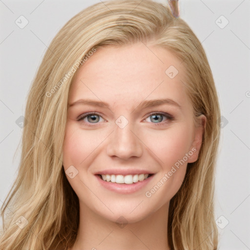 Joyful white young-adult female with long  brown hair and blue eyes