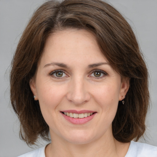 Joyful white adult female with medium  brown hair and brown eyes