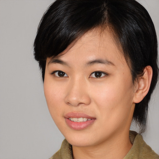 Joyful asian young-adult female with medium  brown hair and brown eyes