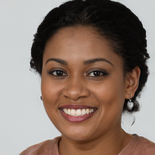 Joyful black young-adult female with medium  black hair and brown eyes