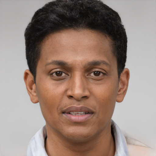 Joyful latino young-adult male with short  brown hair and brown eyes