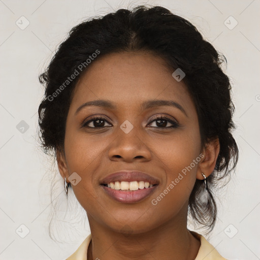 Joyful black young-adult female with long  black hair and brown eyes