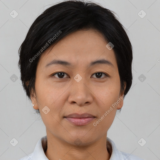 Joyful asian adult female with short  brown hair and brown eyes