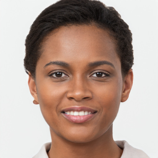 Joyful black young-adult female with short  brown hair and brown eyes