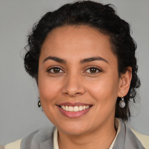 Joyful latino young-adult female with medium  brown hair and brown eyes
