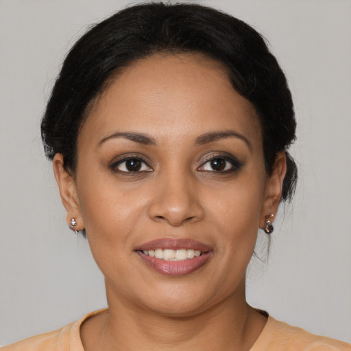 Joyful latino young-adult female with medium  brown hair and brown eyes