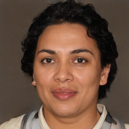 Joyful latino adult female with short  brown hair and brown eyes