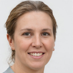 Joyful white adult female with medium  brown hair and grey eyes