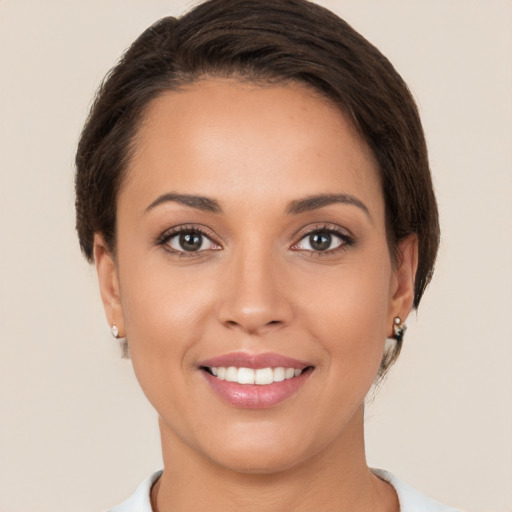 Joyful white young-adult female with short  brown hair and brown eyes