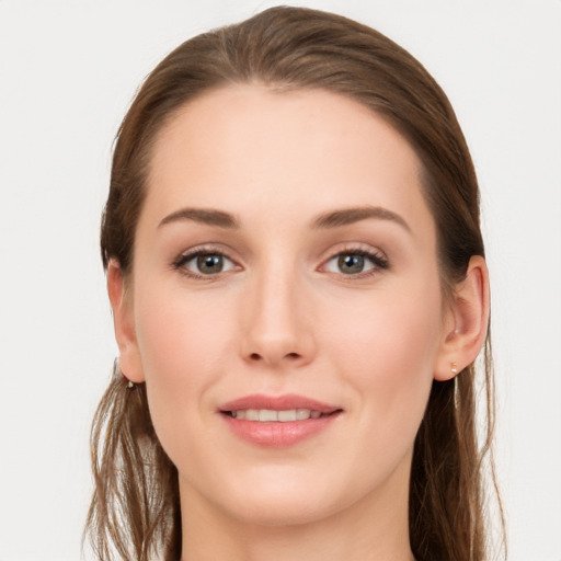 Joyful white young-adult female with long  brown hair and grey eyes