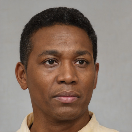 Neutral black adult male with short  black hair and brown eyes