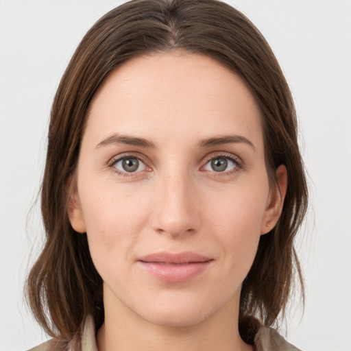 Joyful white young-adult female with medium  brown hair and grey eyes