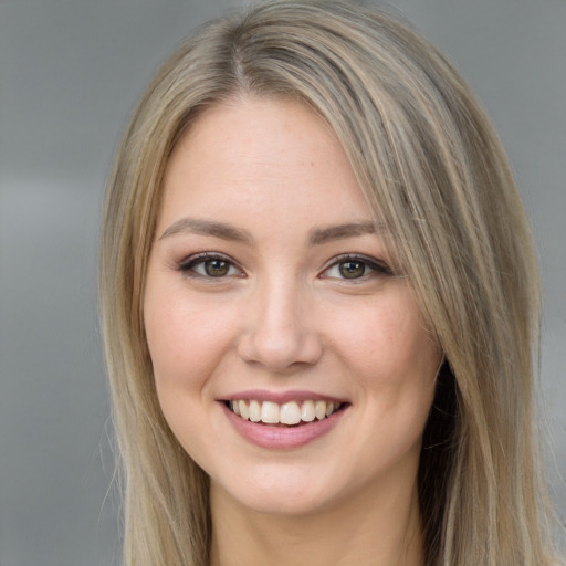 Joyful white young-adult female with long  brown hair and grey eyes