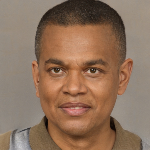 Joyful latino adult male with short  brown hair and brown eyes