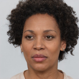 Joyful black adult female with short  brown hair and brown eyes