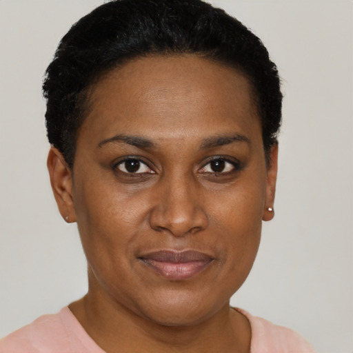 Joyful black adult female with short  black hair and brown eyes