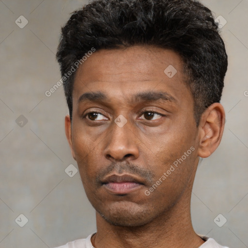 Neutral latino young-adult male with short  black hair and brown eyes