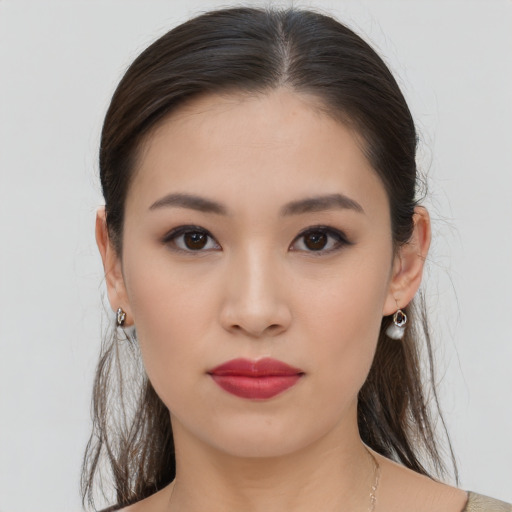 Neutral asian young-adult female with medium  brown hair and brown eyes