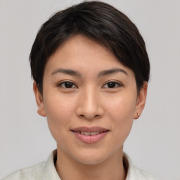 Joyful asian young-adult female with short  brown hair and brown eyes