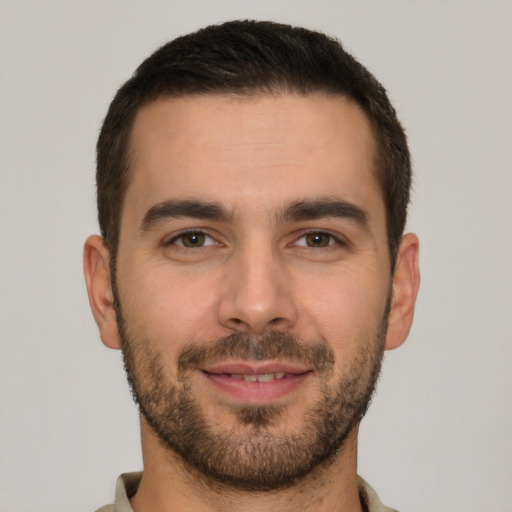 Joyful white young-adult male with short  brown hair and brown eyes