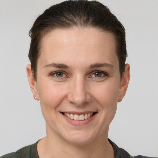 Joyful white young-adult female with short  brown hair and grey eyes