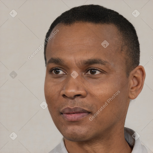 Joyful black young-adult male with short  black hair and brown eyes