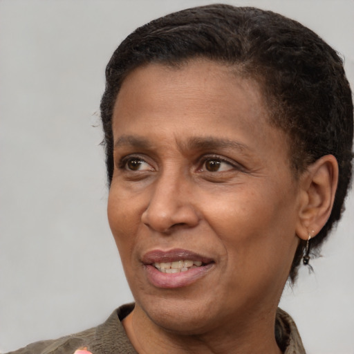 Joyful black adult male with short  brown hair and brown eyes