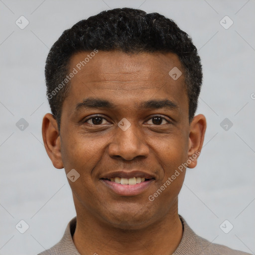 Joyful black young-adult male with short  black hair and brown eyes