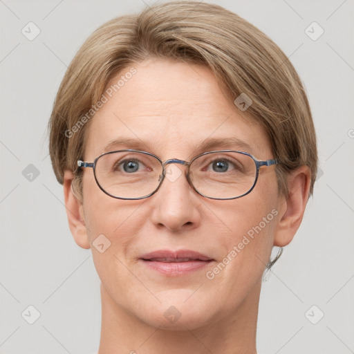 Joyful white adult female with short  brown hair and grey eyes