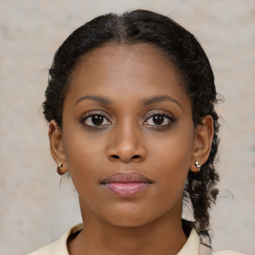 Joyful black young-adult female with medium  brown hair and brown eyes